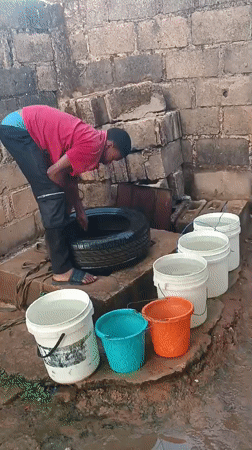 Dawn water collection and morning routines in Bukuru, Nigeria