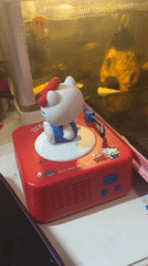Hello Kitty figurine spins atop a miniature toy record player