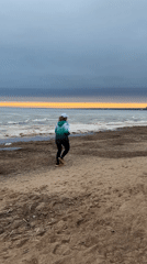 Beachgoers jog and relax in swings near Sankt-Peterburg