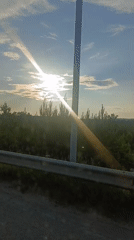 Driving through open countryside on a bright, sunny day