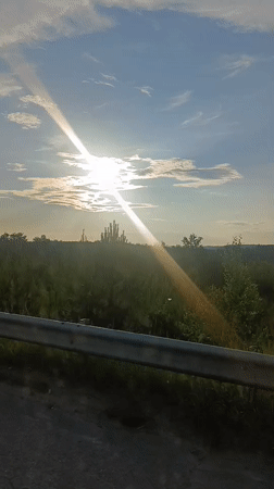 Driving through open countryside on a bright, sunny day