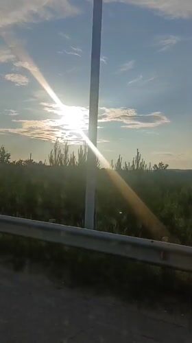 Driving through open countryside on a bright, sunny day