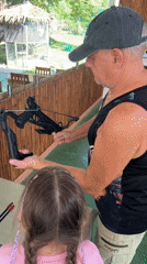 Woman teaches girl target shooting at Thailand recreational facility