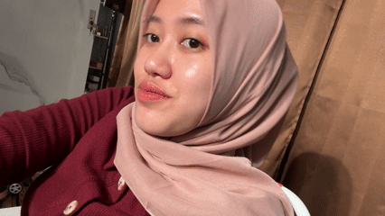 Woman in pink hijab photographed at home in Indonesia