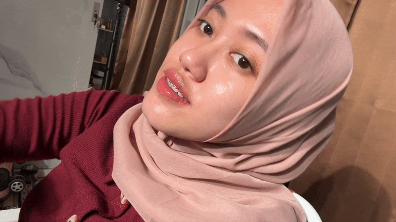 Woman in pink hijab photographed at home in Indonesia