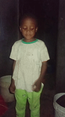 Child observed in poorly lit space with buckets nearby