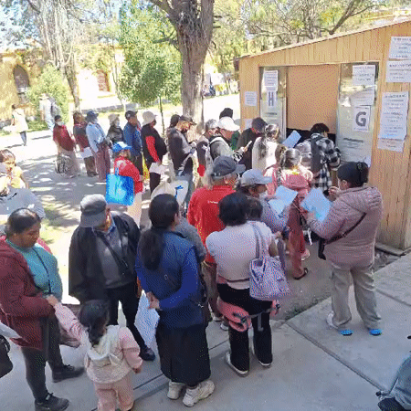 Residents queue with documents for medical appointments in Arequipa