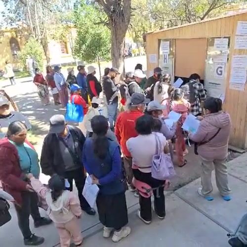 Residents queue with documents for medical appointments in Arequipa