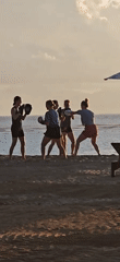 Evening beach activities documented in Denpasar: boxing training, selfies, dogs