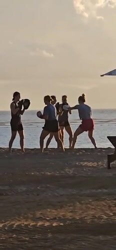 Evening beach activities documented in Denpasar: boxing training, selfies, dogs