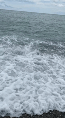 Overcast day on Sokhumi's pebble beach, waves rolling in