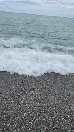 Overcast day on Sokhumi's pebble beach, waves rolling in