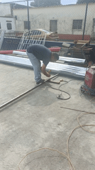 Man cuts metal bar with angle grinder in Tinaquillo
