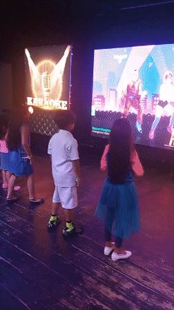 Children dance during late-night karaoke session in Porlamar
