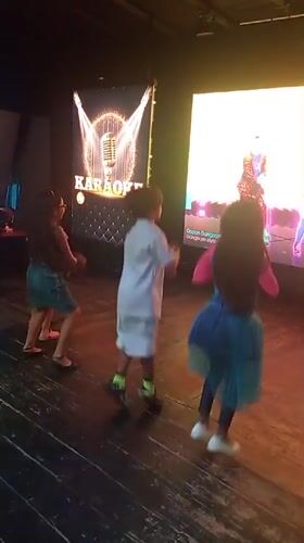 Children dance during late-night karaoke session in Porlamar
