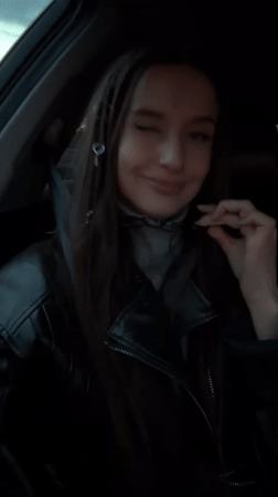 Woman recorded in vehicle interior during evening in Yekaterinburg