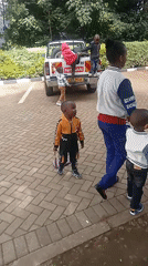 Children play around pickup truck in Maua ward