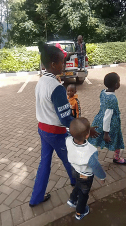 Children play around pickup truck in Maua ward