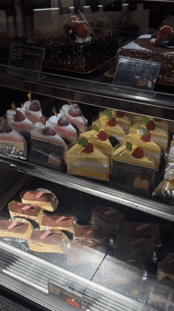 Customer tours 85°C Bakery display cases in Los Angeles