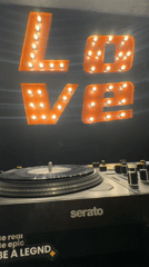 DJ setup spotted with illuminated LOVE sign in Barcelona