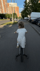 Child plays at Khimki playground in polka dot dress