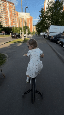 Child plays at Khimki playground in polka dot dress