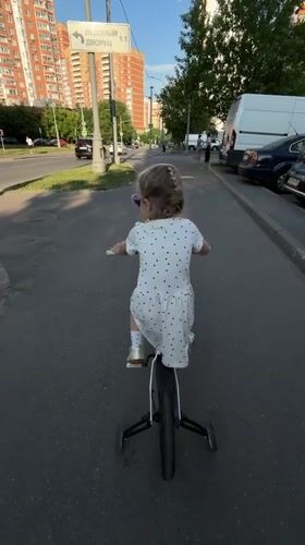 Child plays at Khimki playground in polka dot dress