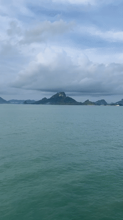 Ferry crosses waters near Thong Nian under cloudy skies