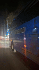 Commercial vehicles spotted on evening street in Keudebayu, Indonesia