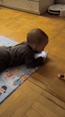 Baby plays on colorful educational mat