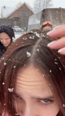 Young people take selfies during snowfall in Gory, Russia