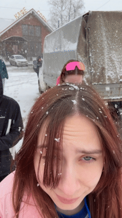 Young people take selfies during snowfall in Gory, Russia