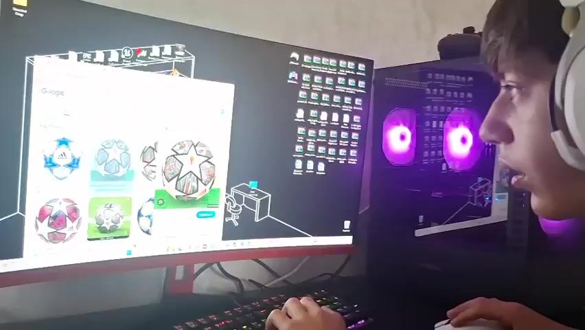 A person, likely a male teenager wearing white headphones, is seated at a desk, looking intently at a computer monitor. The monitor displays a webpage with several images of soccer balls, some with star patterns. To the right of the monitor is a gaming computer tower with purple lights emanating from its fans. The desk also has a keyboard and a mouse. In the background, a microphone on a stand is visible. The room appears to be a home environment. The scene is captured in a close-up, side-profile view of the person.