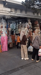 Malioboro Street buzzing with vendors, carriages, and street performance