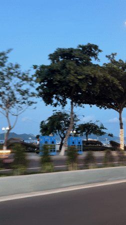 Vehicle travels coastal road in Nha Trang during evening hours