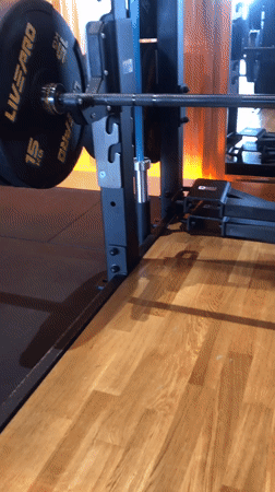 Loaded barbell in a Krasnoyarsk gym squat rack