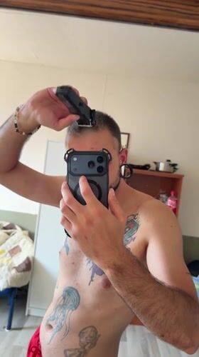 Mirror selfies with tattoos and red shorts, Boxtel