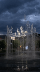 Evening fountain operates under cloudy skies in Shebunino, Russia