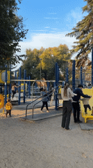 Families enjoy playground time as sunset paints Andes Mountains