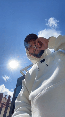 Man in hoodie photographed on sunny day in Strasbourg