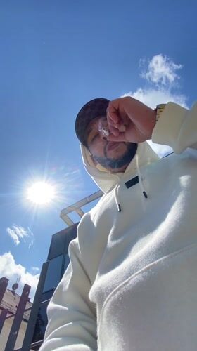 Man in hoodie photographed on sunny day in Strasbourg