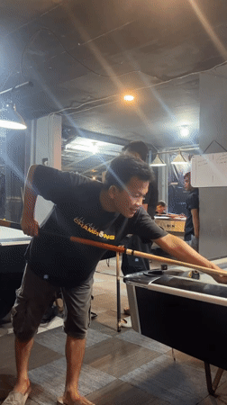 Evening pool session at a dimly lit billiards room in Tangerang
