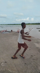 Jumping into the Nun River from Yenagoa's concrete waterfront