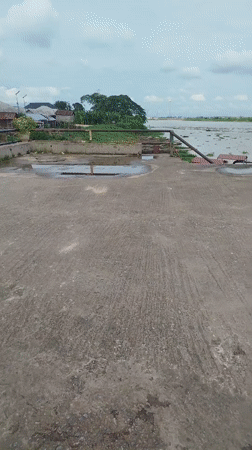 Jumping into the Nun River from Yenagoa's concrete waterfront