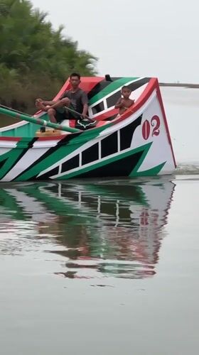 Colorful traditional fishing boats on the water in Reudeuep, Indonesia