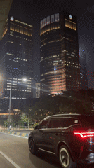 Black SUV drives past office buildings in South Jakarta
