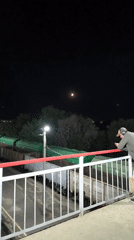 Nighttime at a busy train station, departures and arrivals underway