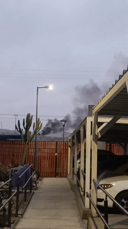 Black smoke rises over building in Arica, Chile
