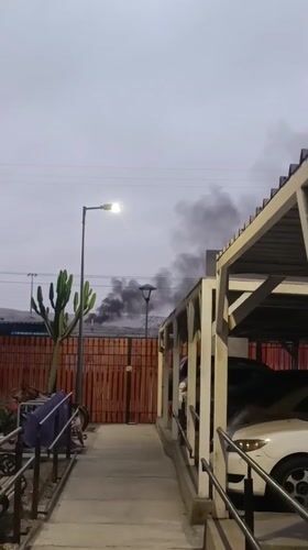 Black smoke rises over building in Arica, Chile
