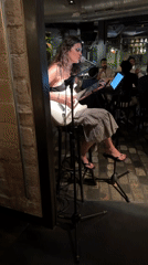 Solo electric guitar performance against a brick wall in Barcelona